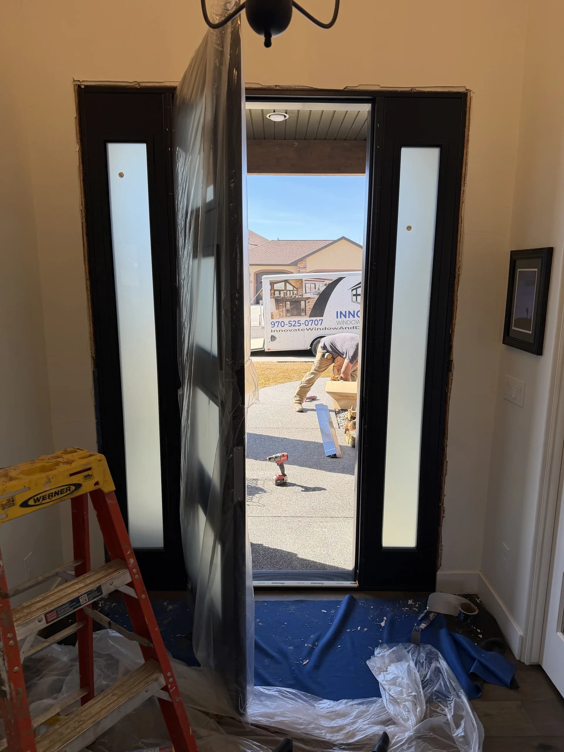 A black-framed glass patio door opening to a mountain view