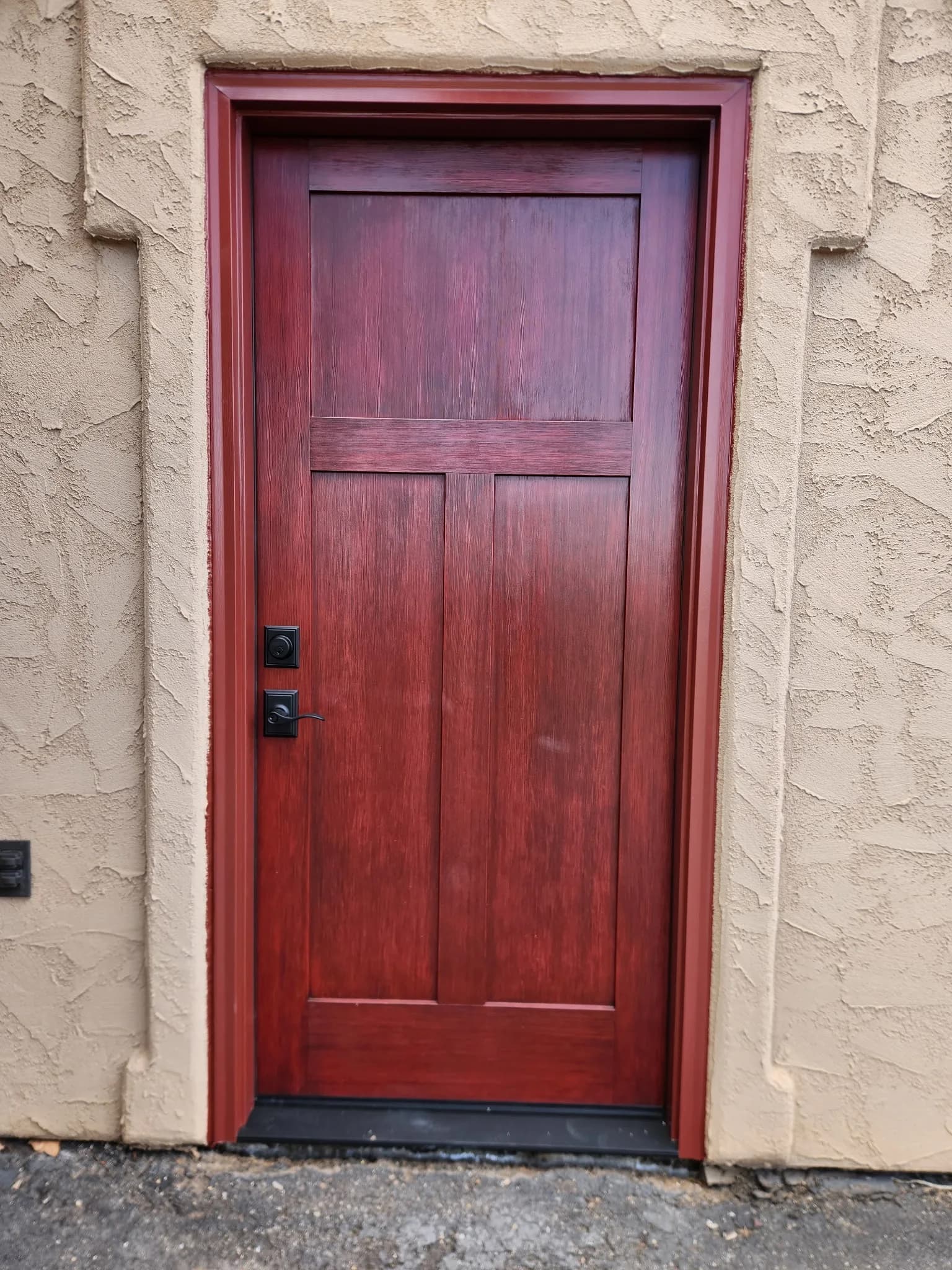 Fiberglass entry door on a red stucco home exterior, Western Colorado installation