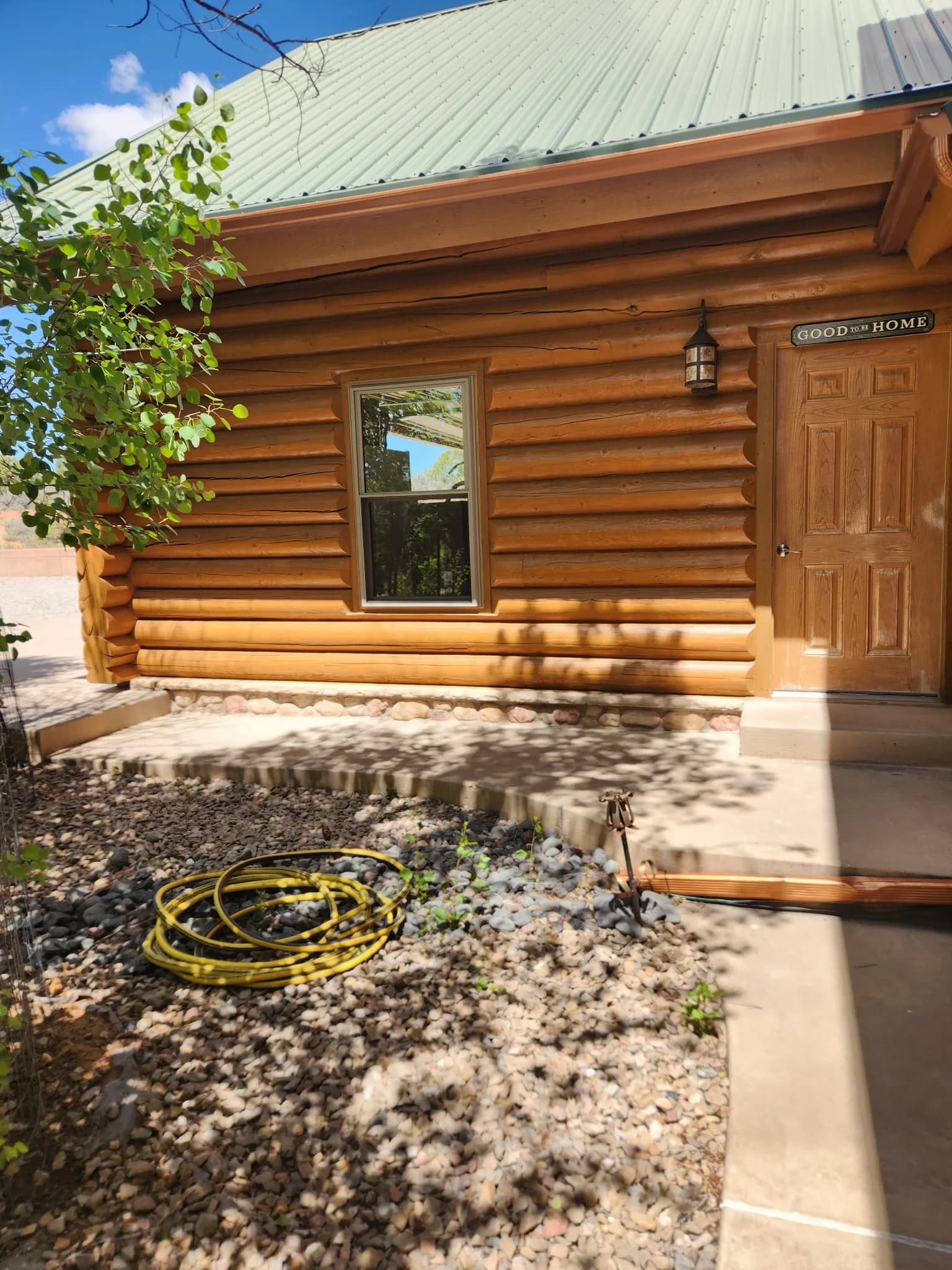 A log cabin home with wood-framed windows in Western Colorado