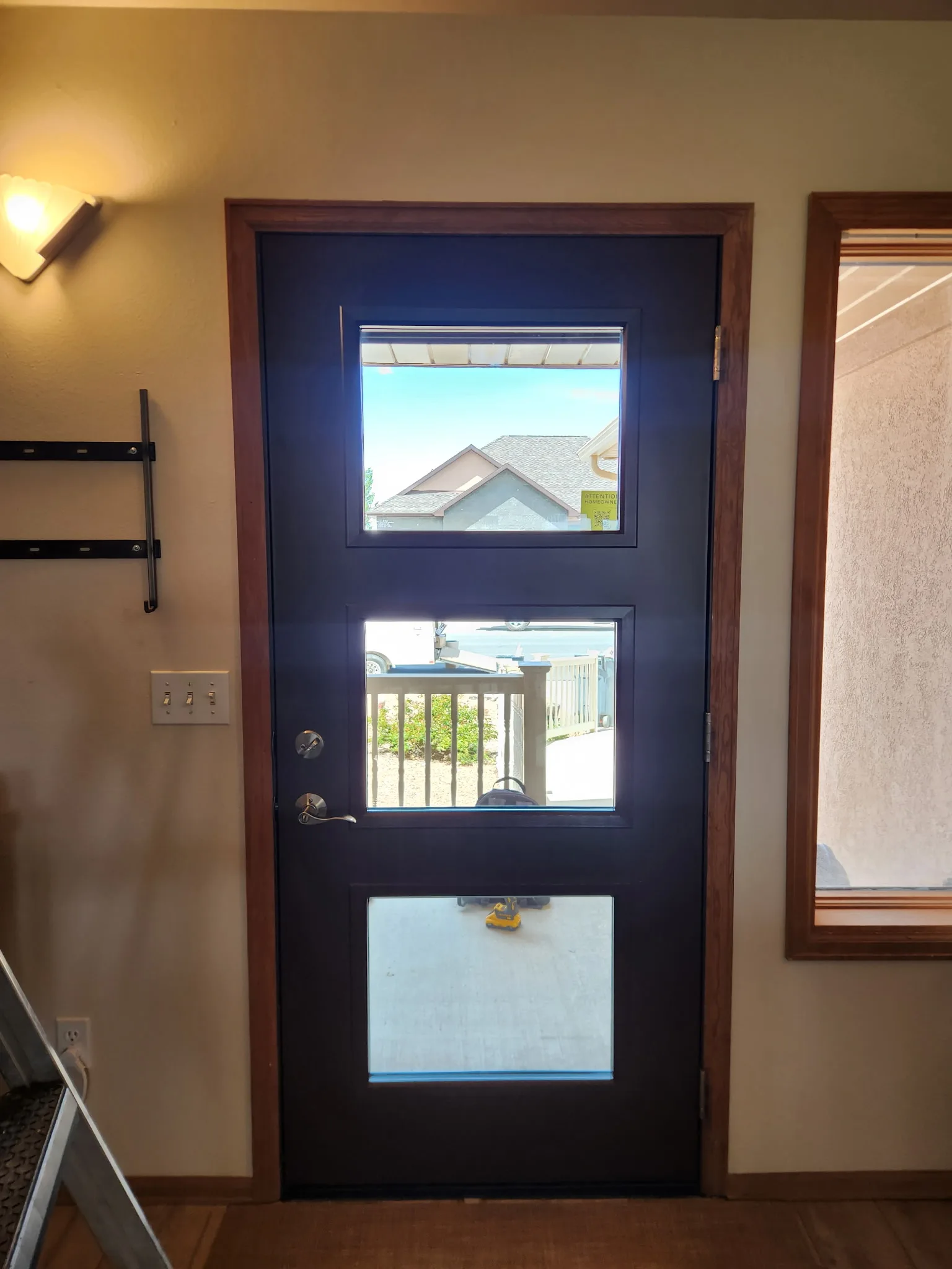 Modern black glass pivot entry door on a contemporary Western Colorado home