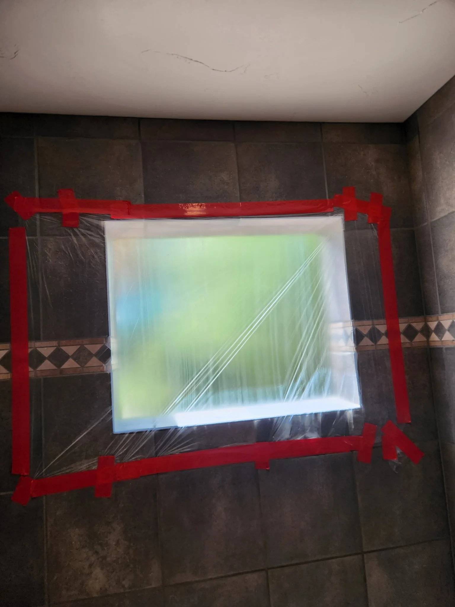 A window opening masked and prepped for installation